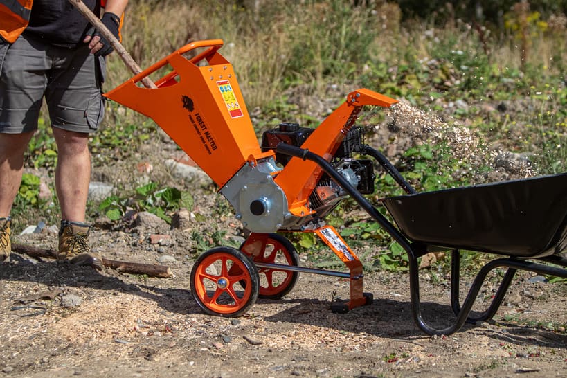 Guide to Buying a Wood Chipper 5 Wood chipper processing branches outdoors