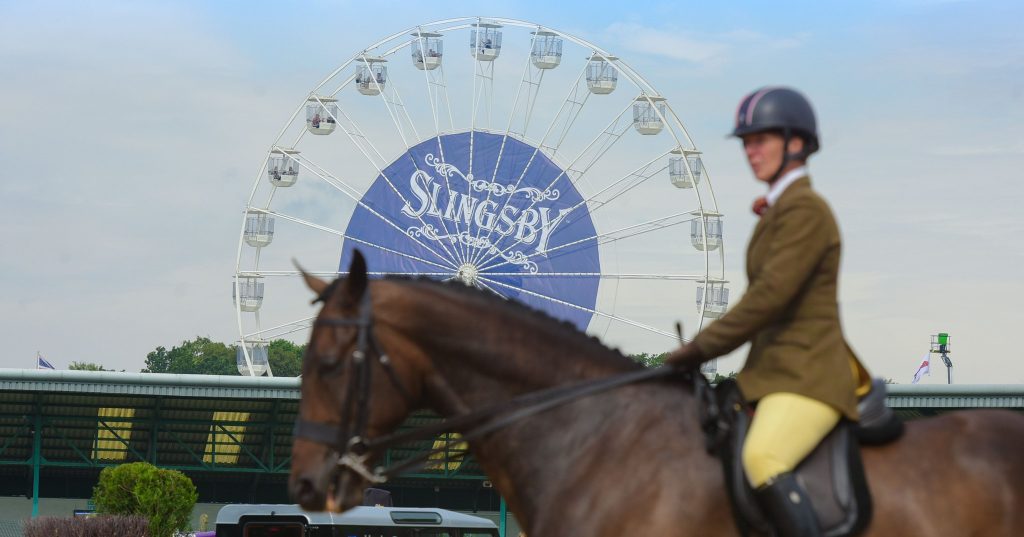Lady riding horse in front of Ferris wheel at Great Yorkshire Agriculture show