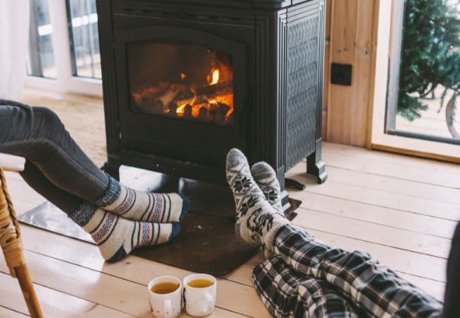 a family enjoying a responsibly-burning wood stove.