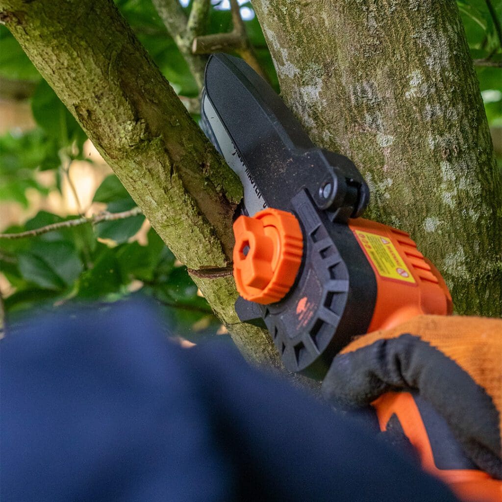 A mini chainsaw cordless garden tools